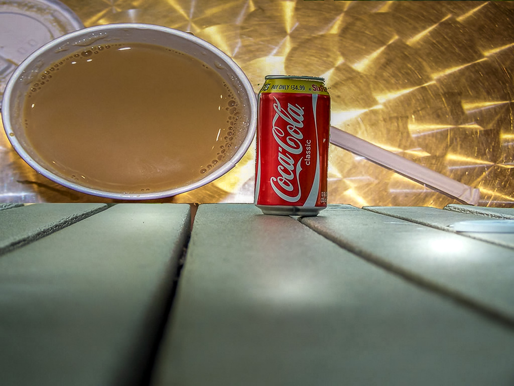 Just seemed like the right photo. Put the Coke on the table and the coffee on the ground.  Added a reflective background.